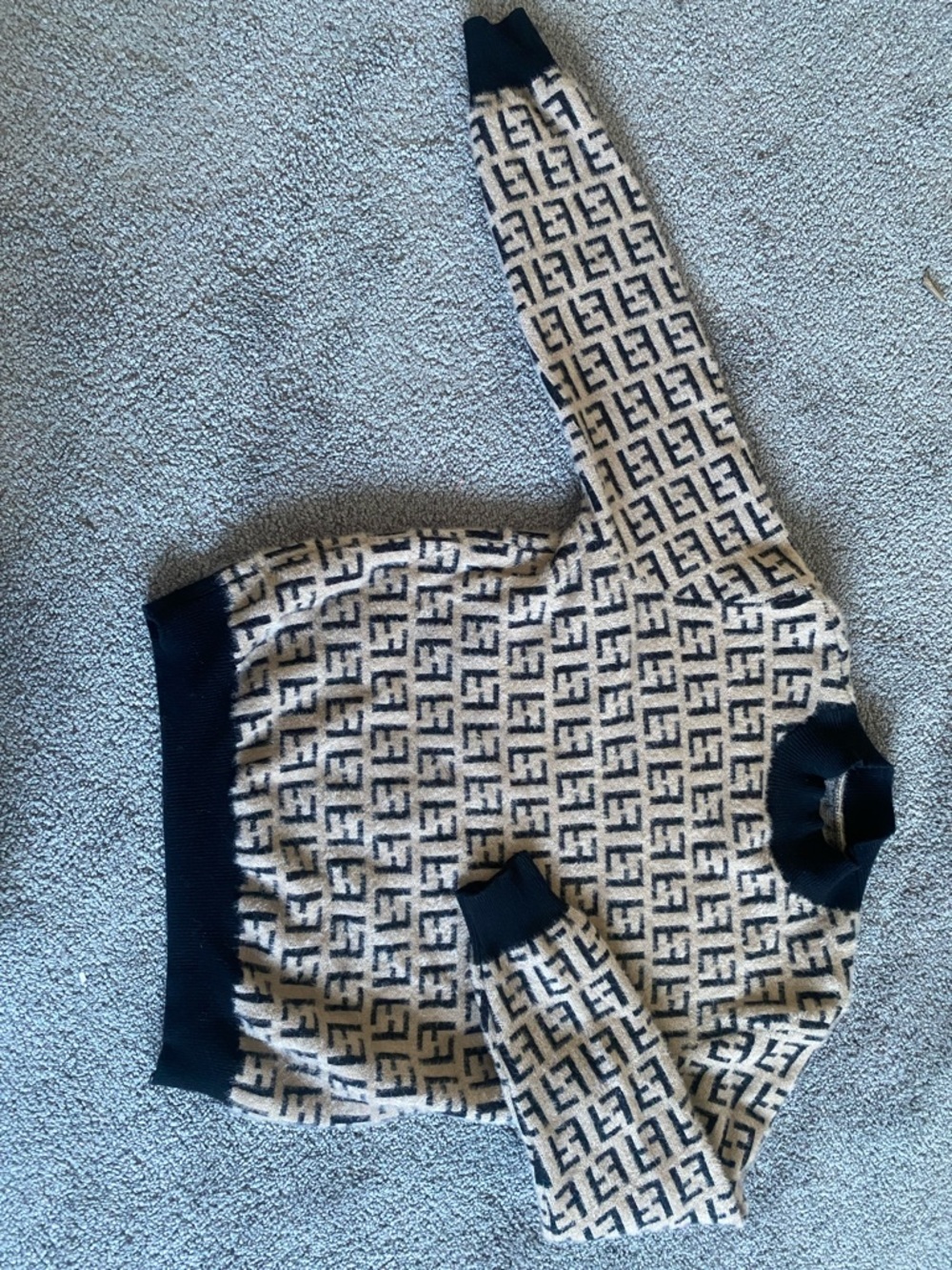 A replica of a Fendi Beige & Black FF Logo Knit Sweater